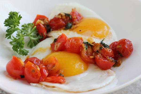 Sauteed Cherry Tomatoes over cooked eggs